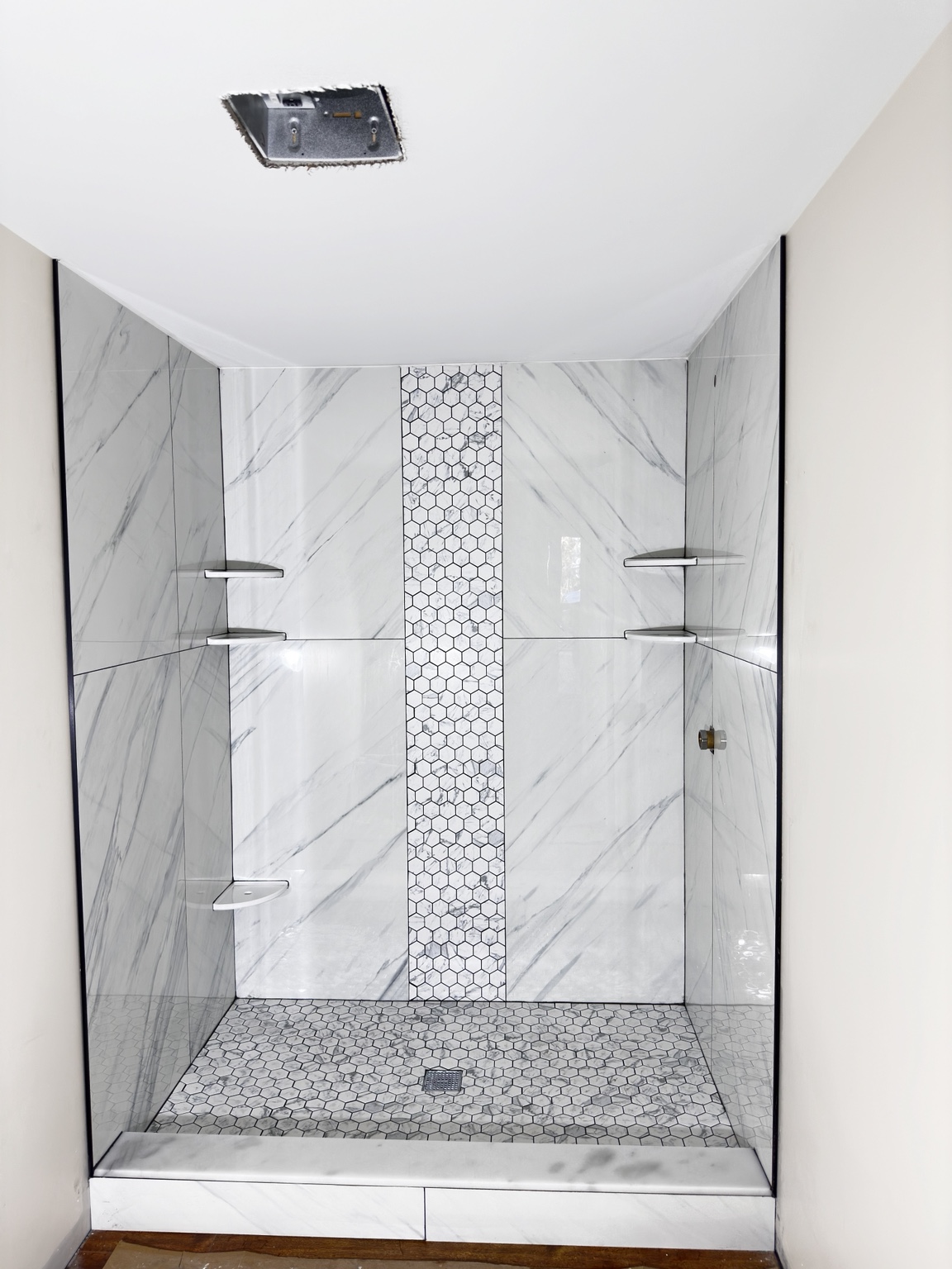 Marble shower with mosaic accent by Straight Line Ceramic Tile in Wilmington NC