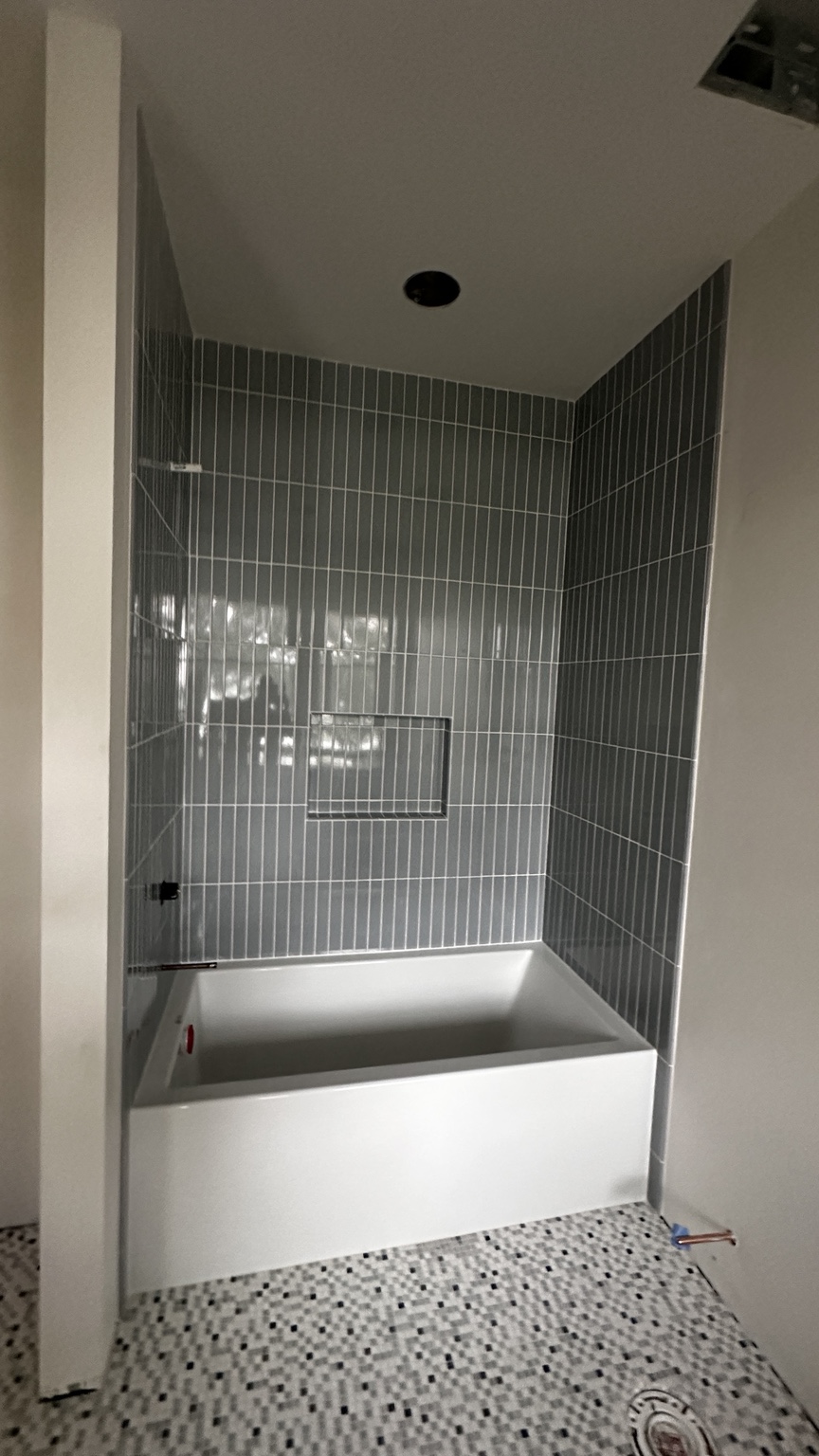 Gray vertical tile tub surround by Straight Line Ceramic Tile in Wilmington NC