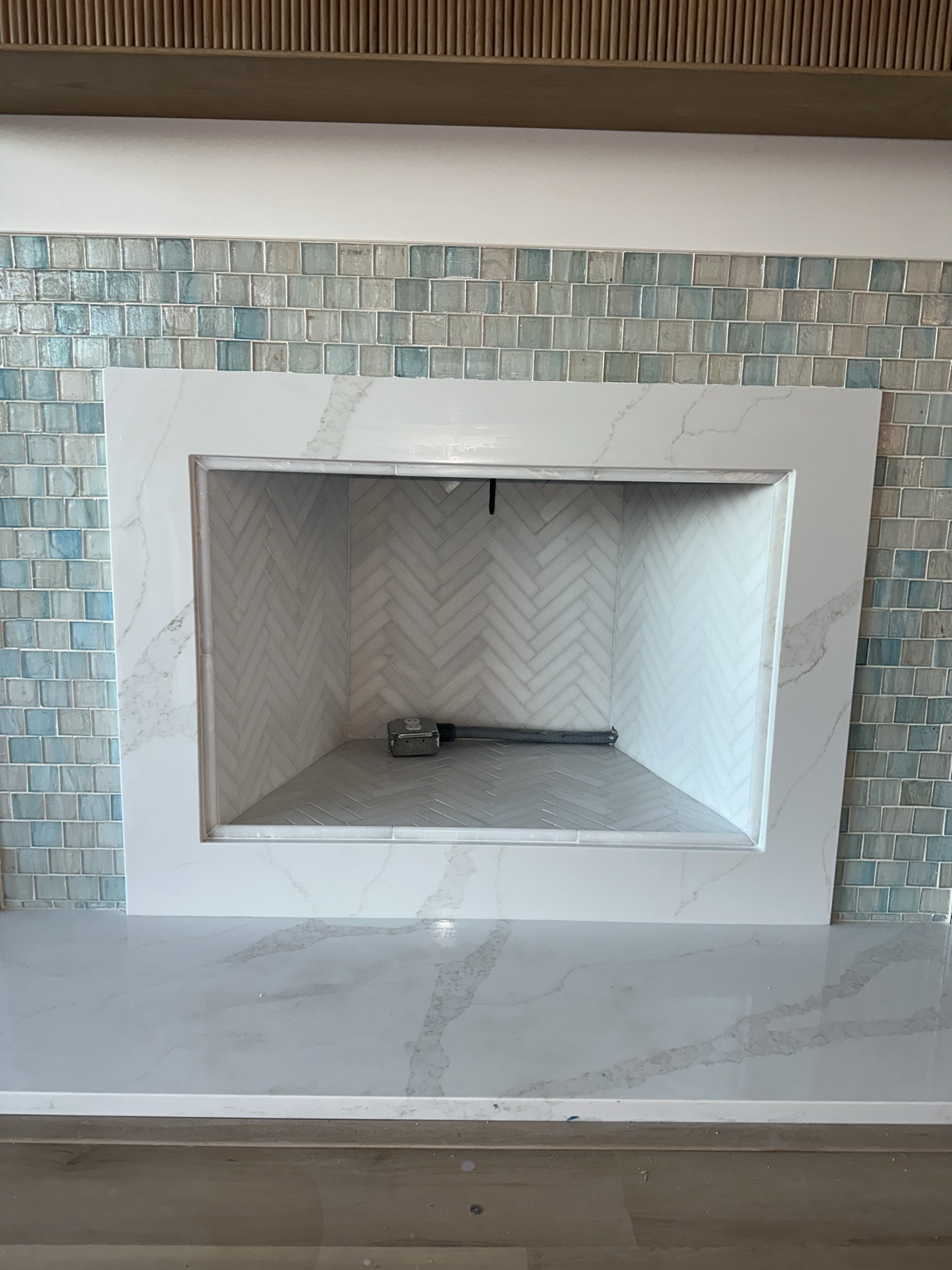 Mosaic tile fireplace surround by Straight Line Ceramic Tile in Wilmington NC