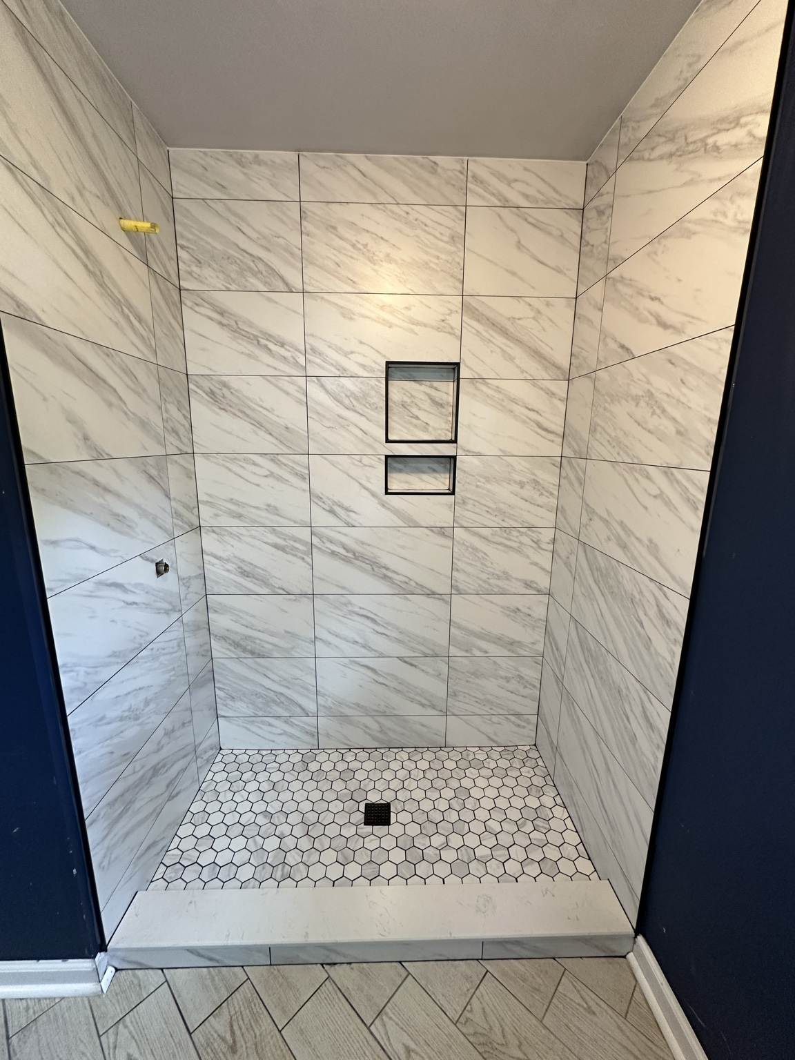Marble look walk in shower by Straight Line Ceramic Tile in Wilmington NC